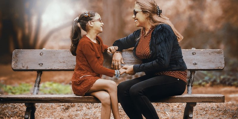 Woman with daughter_bench