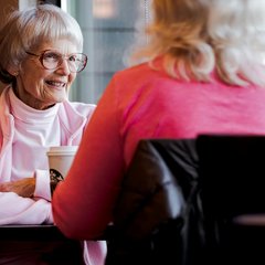 Two women talking over coffee